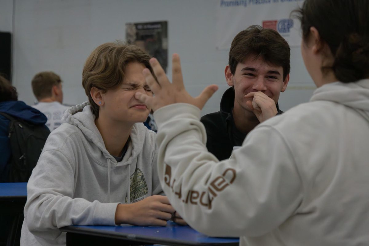 Juniors Luke Stallings and Ryan Latta laugh at a joke made by a friend at the table. The three had lots of fun spending time with one another during the breakfast and laughed together during the event. 