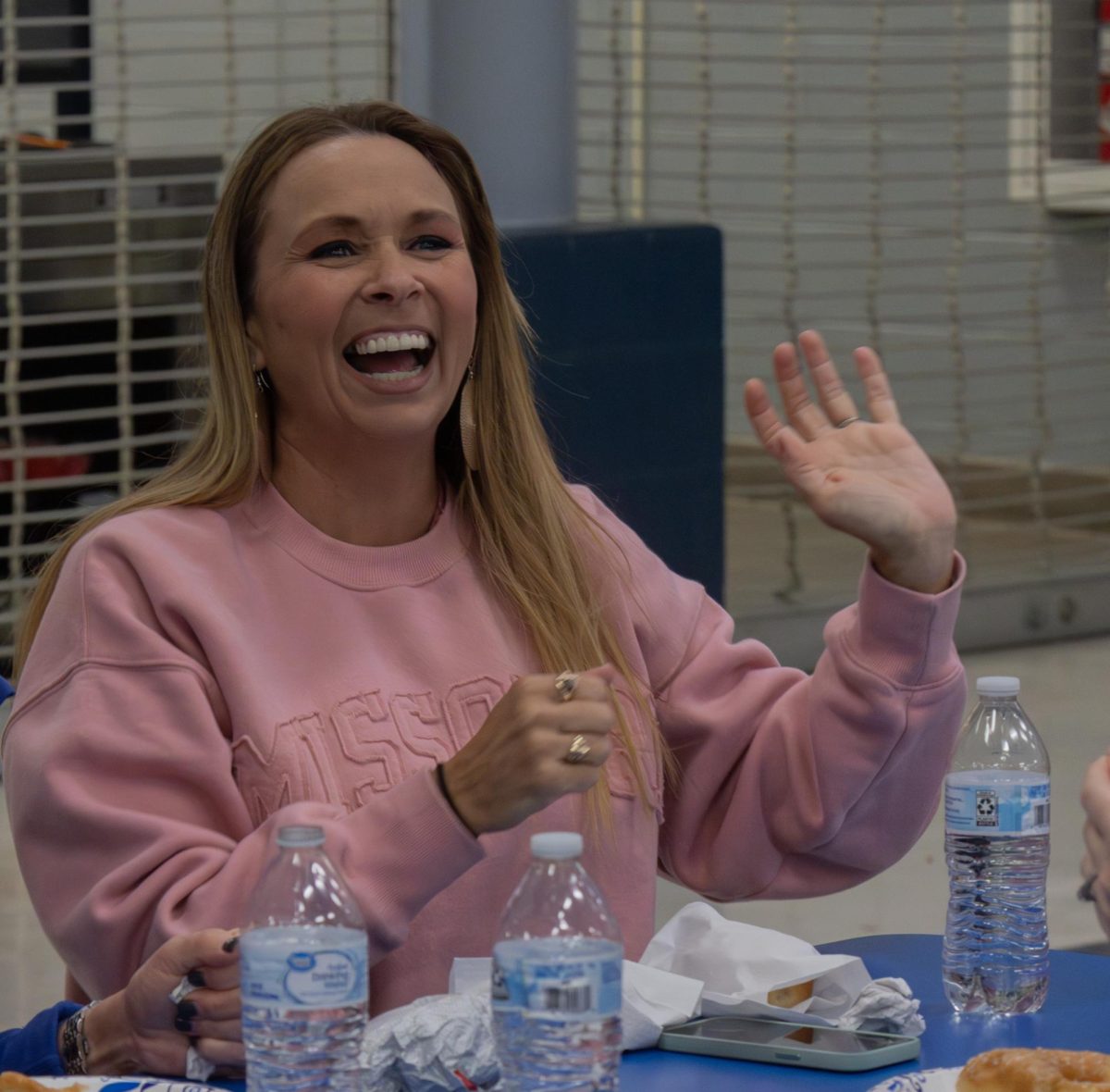 As Ms. Laurie Fay recognizes a student that has won the raffle, she displays her excitement for the student. The student then came to claim their prize as Fay congratulated them. 
