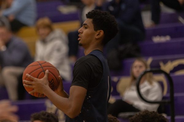 As he holds the ball junior Xavier Morrison looks for an open teammate to pass to. Morrison takes a deep breath and collects himself to get ready for the next play. 
