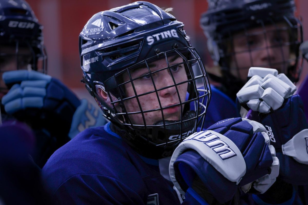 Sophomore Patrick Davie watches his coach as they give instructions to the team during a period break. He is focused completely on the coach’s lecture like they are the most important words to be heard, because to him they are. While attending a hockey academy as his full time schooling, he still makes time to attend every high school game he can. His hardwork and dedication to the sport earned him the title of Rookie of the Year while only being a freshman. Blocking out the world and his personal life, when Davie gets on the ice his only world is the game. 

“I like being on the high school team because it gives me a chance to see people I used to go to school with,” Davie said. “Plus it allows me to kind of relax from my other intense hockey team.”

Davie continues to balance his club and school teams, while attending a high intensity training academy with ease. He has hockey almost every day while still maintaining his daily schedule, and always staying in his element. 