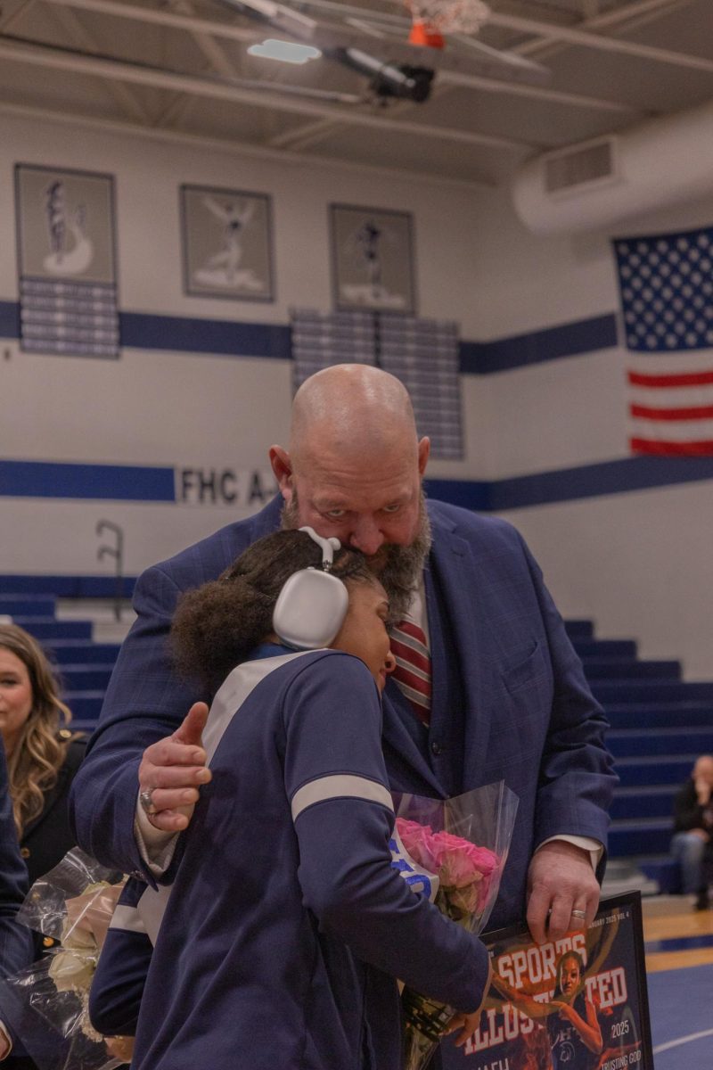 While hugging Head Coach Kurt Kruse, senior Nevaeh Smith cries as she is handed her senior banner. Smith proceeded to thank Kruse for everything he has done for her.