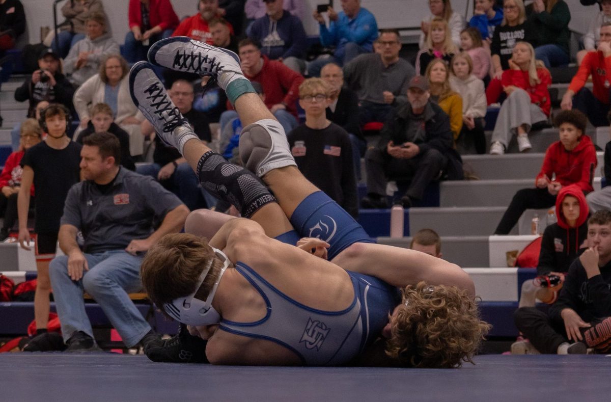 As he lays on his back, sophomore Sebastian Diechkaus-Schumer works to belly out to keep himself from getting pinned. Diechkaus-Schumer grabs his opponent's leg and tries to work up from his back to get the reversal. 