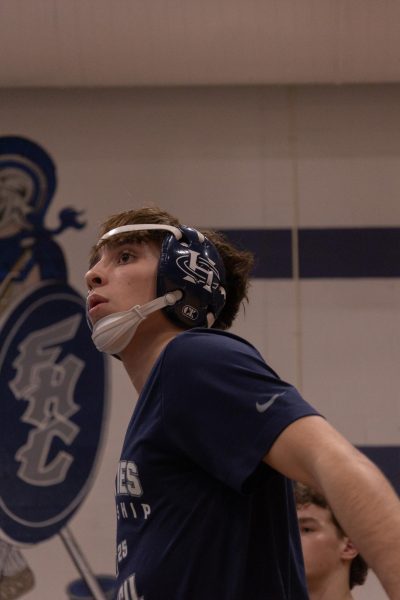 unior Chase Gray jumps up and down to get loose before his match. Gray then walked over to his team so they could send him out. 