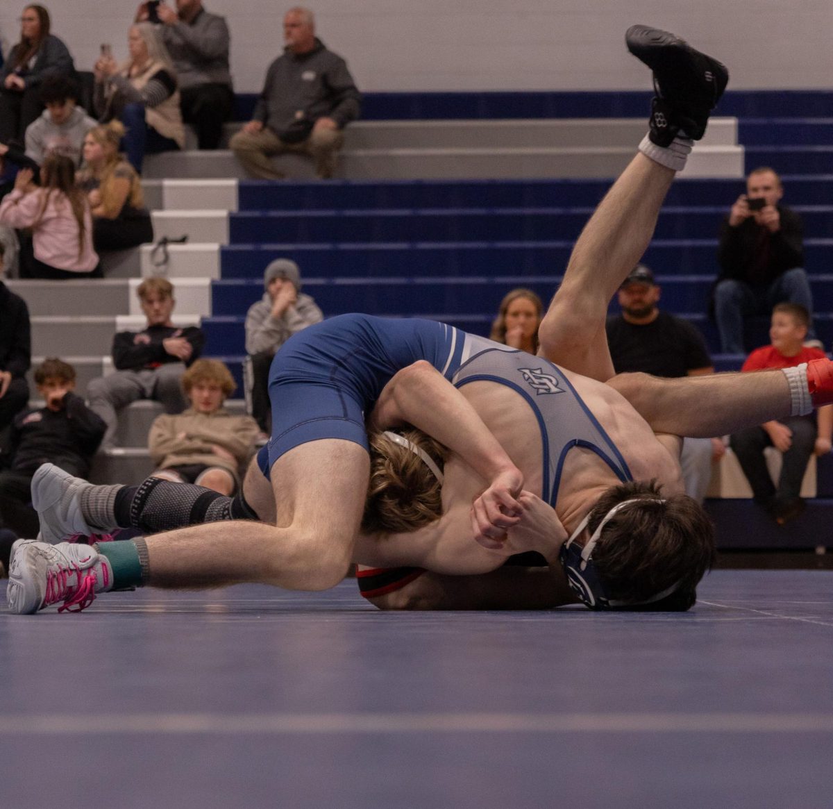 Senior Mason Wideman squeezes his opponent’s head. Wideman then puts his opponent’s head on the ground to make sure his opponent is pinned. 