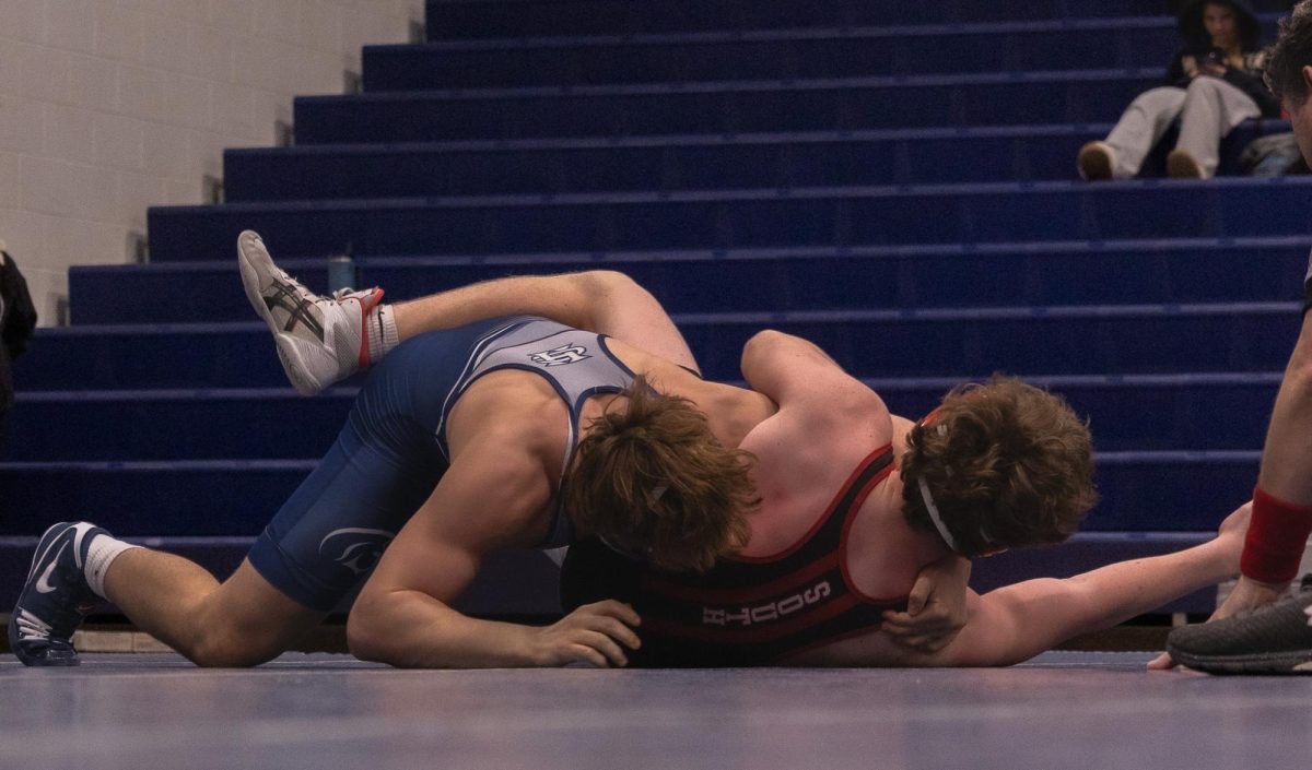 Senior Owen McCracken pulls his opponents back to the mat. McCracken then puts pressure on him so he cannot get up. 