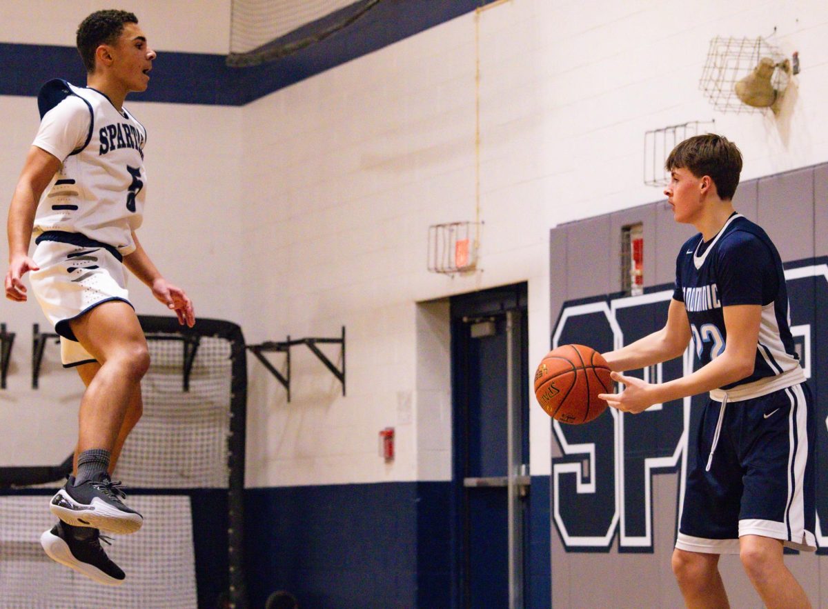 Jumping in the air, freshman Lucas Allen defends an inbounder. Allen jumped and shouted to block the inbounder’s view and force a bad pass. 