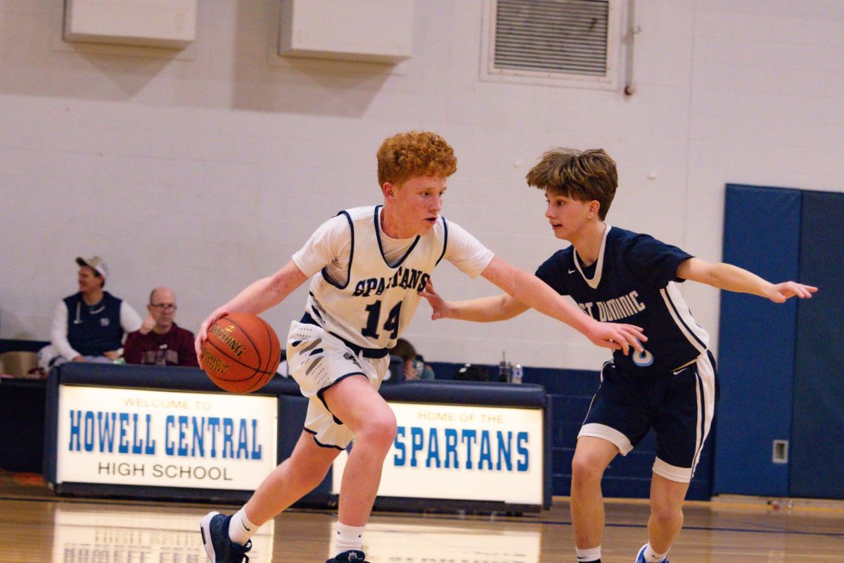 Freshman Owen Rothermich uses his arm to protect the ball and create space between himself and his defender. After facing tough defensive pressure in the backcourt, Rothermich pushed past his defender to cross half court. 