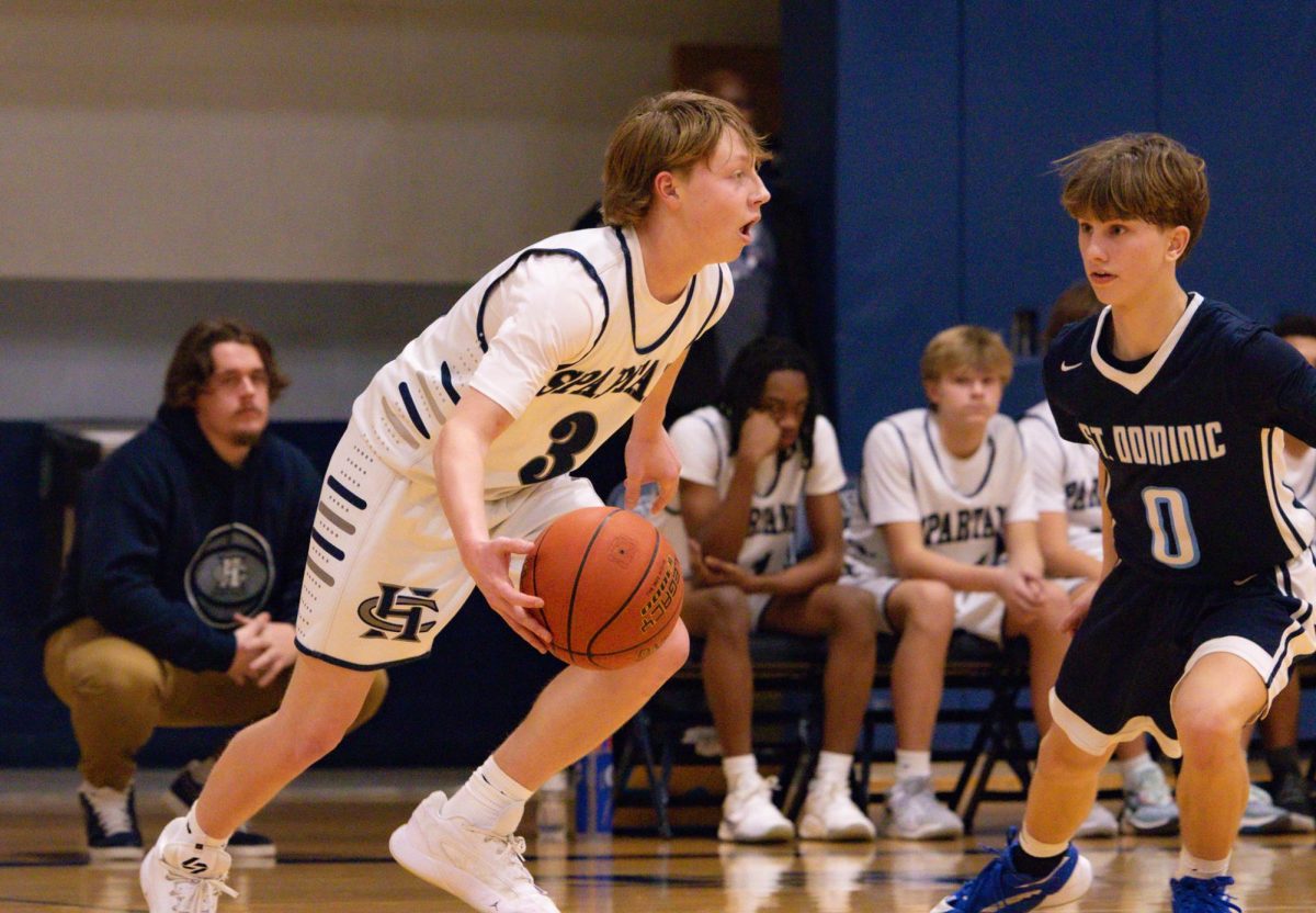 Calling for a teammate, freshman Breyer Beal prepares to start an offensive play. Beal dribbled past his defender before passing the ball out to a teammate to shoot the three.