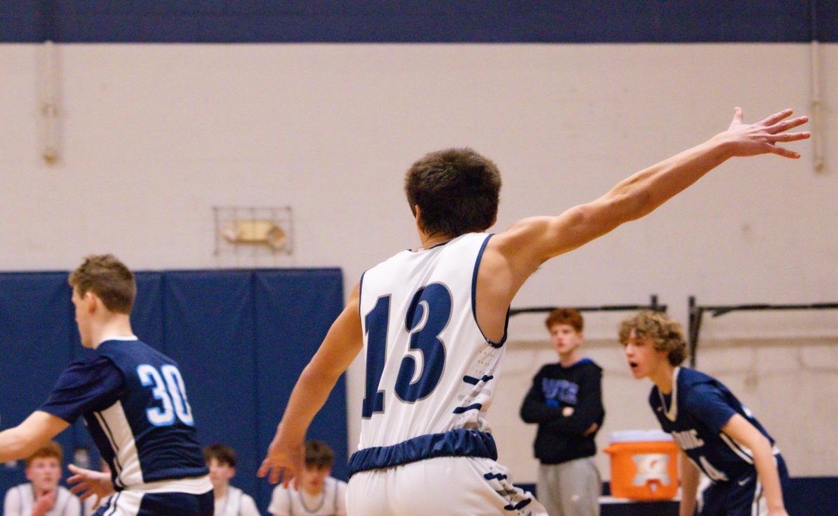 With one arm reaching toward the basket, freshman Nick Hopkins calls for the ball. Seeing a gap in the defense, Hopkins cut into the paint.