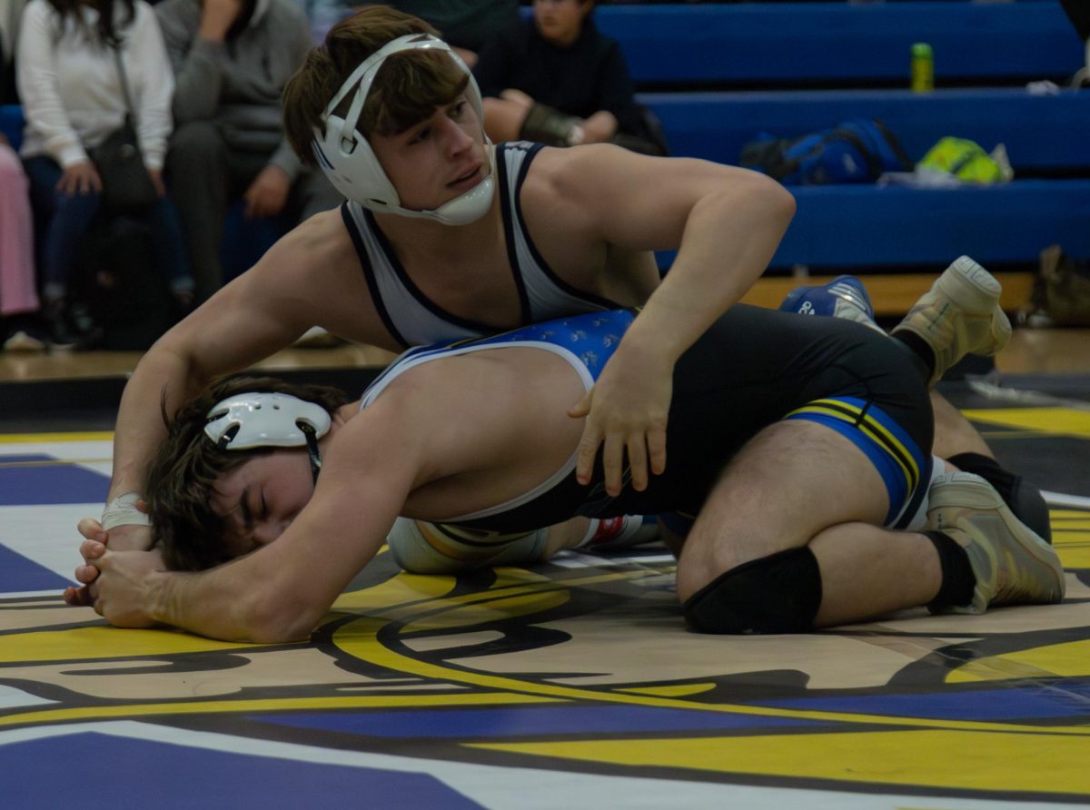 Senior Owen McCracken looks to his left at his coaches for instruction on what move to attempt next. McCracken was able to put himself into a good enough spot so that he was able to look away from the match for a moment. 