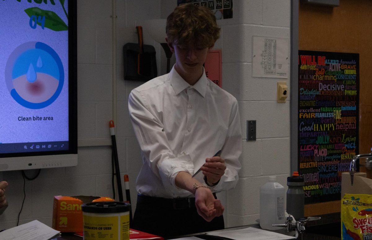 Demonstrating how to remove a tick that is embedded into the skin, Lucas Ostermeyer holds a pair of tweezers on his skin's surface. The most efficient way to remove a tick is carefully with needle nose tweezers to ensure the tick is completely out.