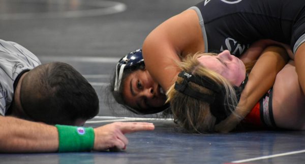 Maleah Eichelberger, freshman, stares at the referee as she waits for the whistle. Eichelberger stayed locked around her opponent to make sure she secured a win.
