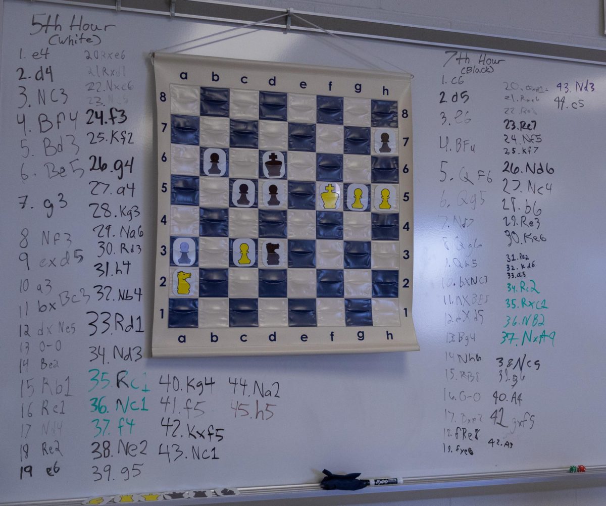 Junior Shane Bourquin played the last move, white pawn to h5, and black has not responded yet. This chess game has been going on for multiple months and all of the moves are written beside the board. 