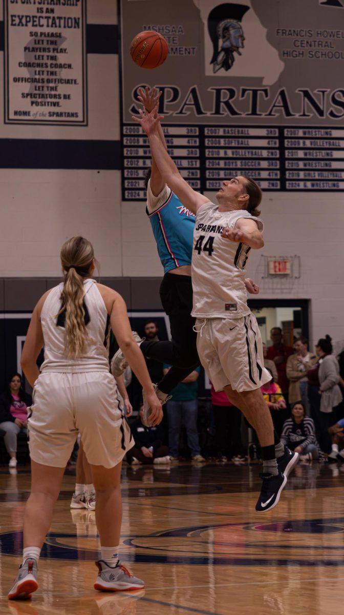 To start off the teacher versus student basketball game during the pep assembly on, Coach Andrew Carter and senior Andrew Martin jump up to compete for the ball. Martin was able to swat the ball to his teammate first which allowed the students to start on offense. 
