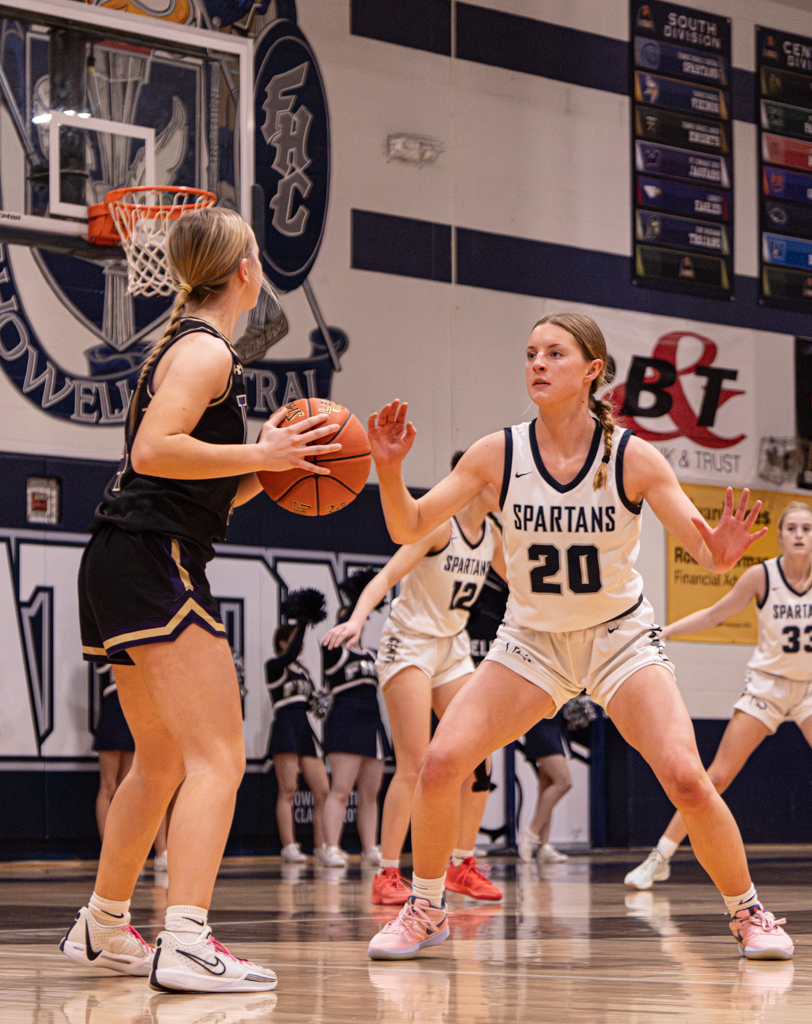 Junior Sam Taylor puts her hands up as she defends against the Troy player, hoping to get a steal. Players put their hands up on defense to make themselves bigger and harder to get around.