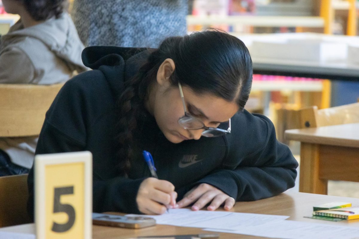 One of the invited students carefully writes her improvements on the sheet provided by teachers. Each student received a brainstorming sheet to help them come up with and keep track of their ideas.