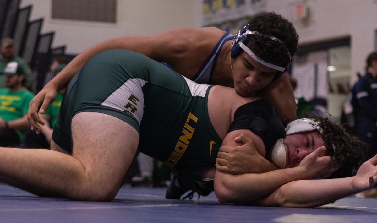 After cross-facing his opponent, junior Garabed Sams reaches his other hand between his opponents legs to begin locking up a cradle. Shortly before this, Sams’ opponent called injury time due to strain on his shoulder.