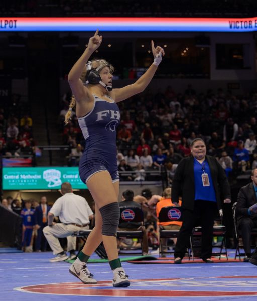  In the final match of her high school career, senior Kailey Benson throws her hands up and shakes her fingers. Benson placed first at the state tournament in the 130-pound weight class with an undefeated record this season and hasn't lost a match since her sophomore year.