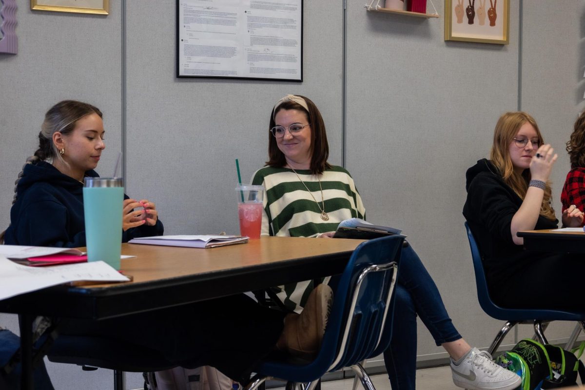 Sarah LaRue smiles as students in her AP Literature and Composition class share their opinions on poems. During their own version of March Madness, the class reviewed 32 poems and put them against one another in a bracket: choosing between which ones were their favorites or which were the most complex.