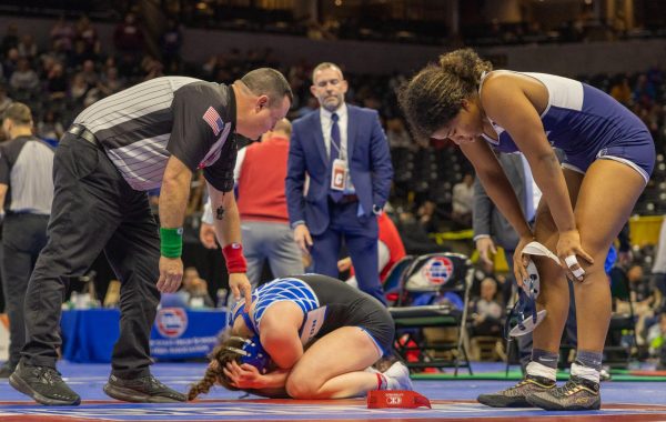 After beating her opponent in the 155 lbs. weight class, senior Dana Thee Sanchez puts her hands on her knees to catch her breath. Her opponent attempted to console herself before she had to shake Sanchez’s hand.