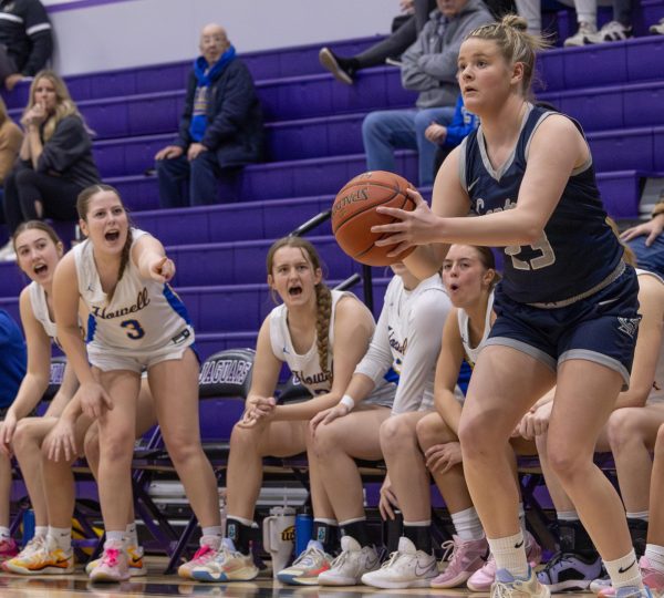 Shooting from the three point line, senior Addie Henderson blocks out all distraction as the Howell bench yells at her. Outside noises can cause players to become unfocused and miss their wide open shots.