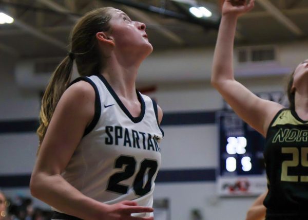 As the Knights try their hardest to get more baskets, Sam Taylor gazes up at the Spartans basket. Taylor watches to find out whether the points will be awarded to their competitors or if she is able to steal the ball back.