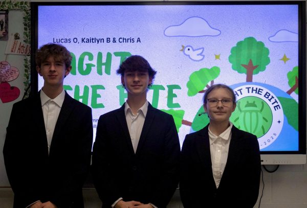 Freshman Lucas Ostermeyer and sophomores Chris Allen and Kaitlyn Belina stand from left to right, respectively, in front of their "Fight the Bite!" presentation advocating and fostering awareness for tick-borne illnesses. The team will present to a panel of judges at the State Leadership Conference in Rolla, MO, on Monday, March 24. Photo courtesy of Chris Allen