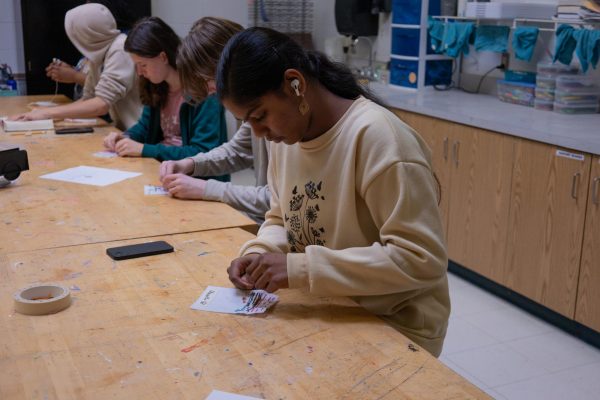 Dhanvitha Bodapati works on a stitching project in Mrs. Ridlen's Introduction to Art class. The Intro to Art classes have covered the basics for multiple art forms for years: including those involving fabric.