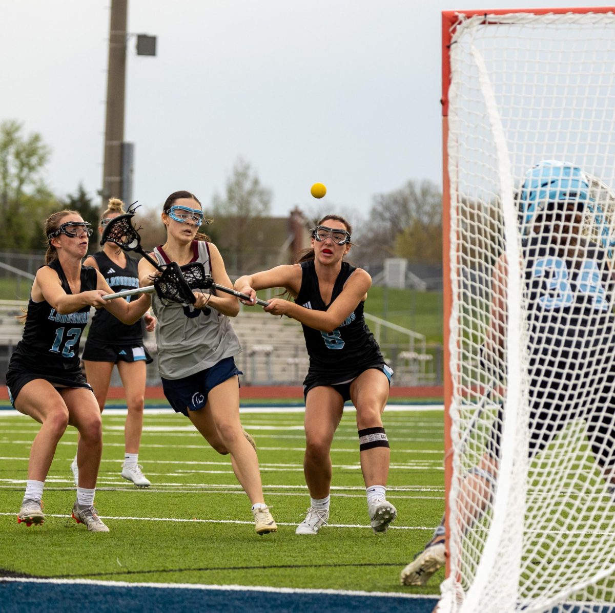 During the second quarter of the game, junior Brianna Lewis avoids her defenders and launches the ball into the net. The ball glided past Parkway West’s goalie, earning a goal for the team. 