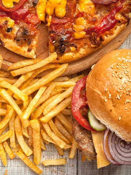 An image including french fries, pizza, and a hamburger.  These three foods are generally the most popular forms of fast food. 