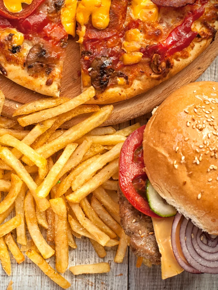 An image including french fries, pizza, and a hamburger.  These three foods are generally the most popular forms of fast food. 