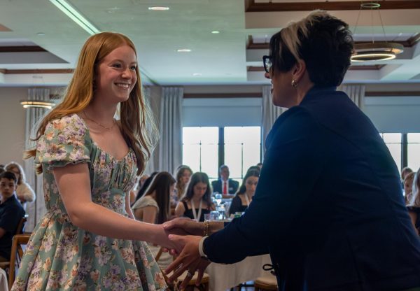 With a radiant smile, senior Maggie Meyer firmly grabs Suzanne Leake’s hand as Leake compliments her hard work. Meyers plans after high school are to attend Mizzou, with the hopes of becoming a nutritionist. 