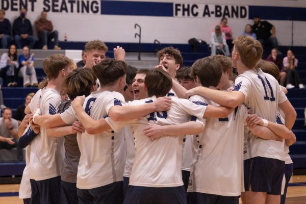  Before the game starts senior Chase Williams stands in the middle of the circle and talks to the team. Williams got the boys hype and locked in for their first set.