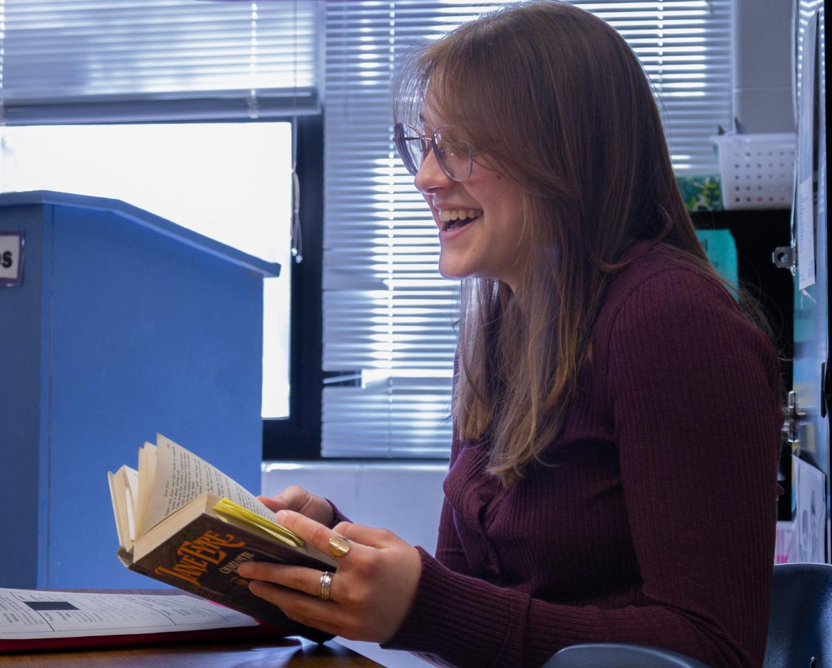 While discussing parts of the book Jane Eyre by Charlotte Brontë, senior Violet Gallagher laughs with her group. One of her teammates had brought up a comical point during the story.