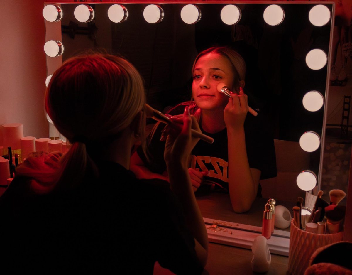 Ruled by the sun, Leo's are known to be very confident. While doing her makeup, senior Dani Jansen smiles into the mirror, highlighting her confidence and positive personality. 