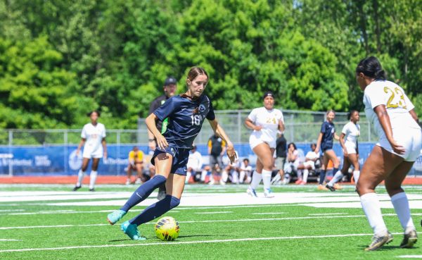 Junior Claire Casler  slides to the right as they dribble the ball past the other team’s defensemen. With a concentrated demeanor, Casler rushed past to score yet another goal.