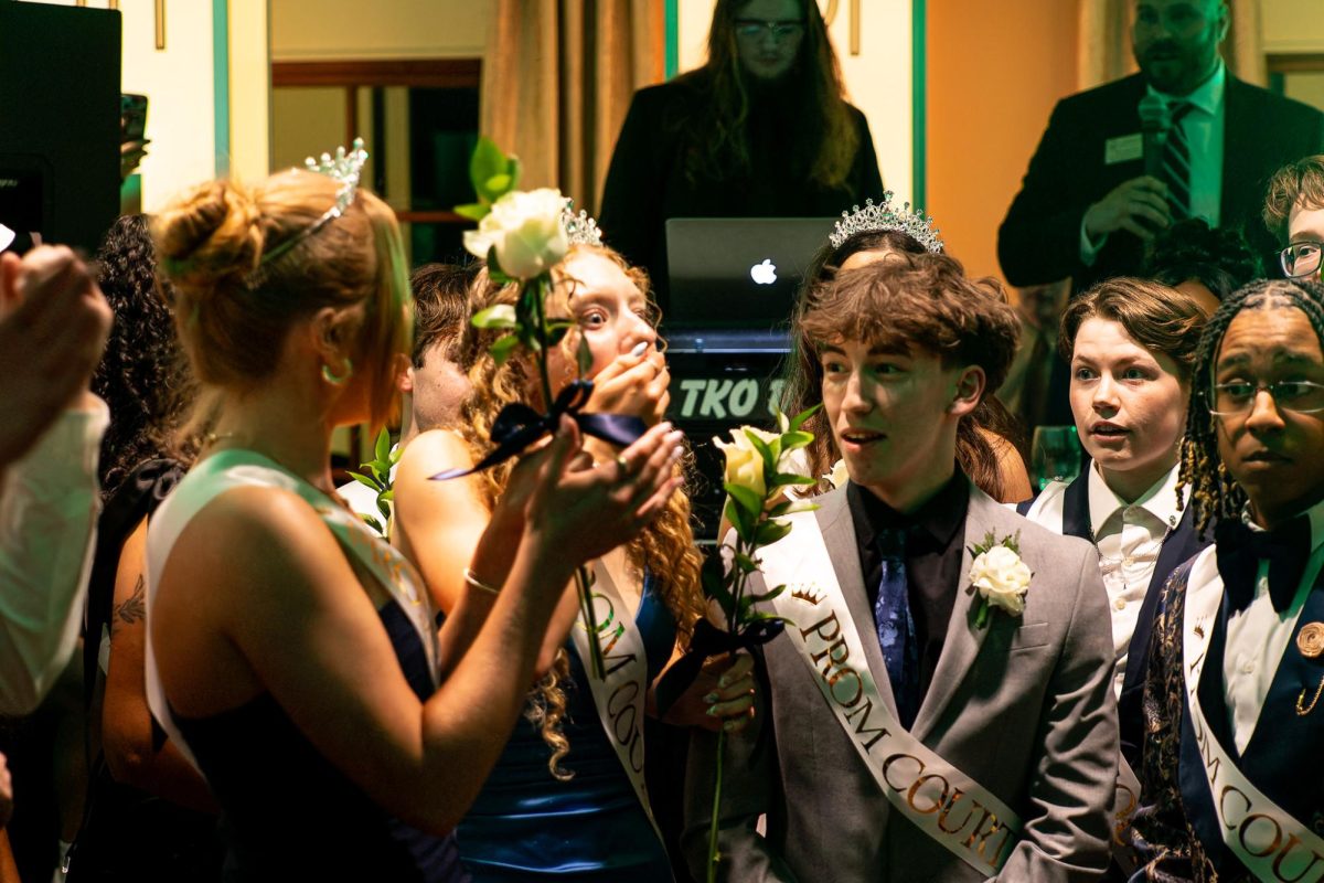 Surrounded by her fellow prom court candidates, senior Audrey Webb stands in shock after hearing she is the 2025 prom queen. Leading up to the day of prom, multiple students campaigned for the titles of Prom King and Queen.