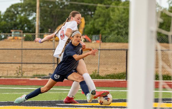 As she drives the ball towards the goal, freshman Lily Limpert gets tripped by her defender from Ursuline. The referee did not call a foul on the Ursuline player, which resulted in an uproar of displeasure from the crowd. 