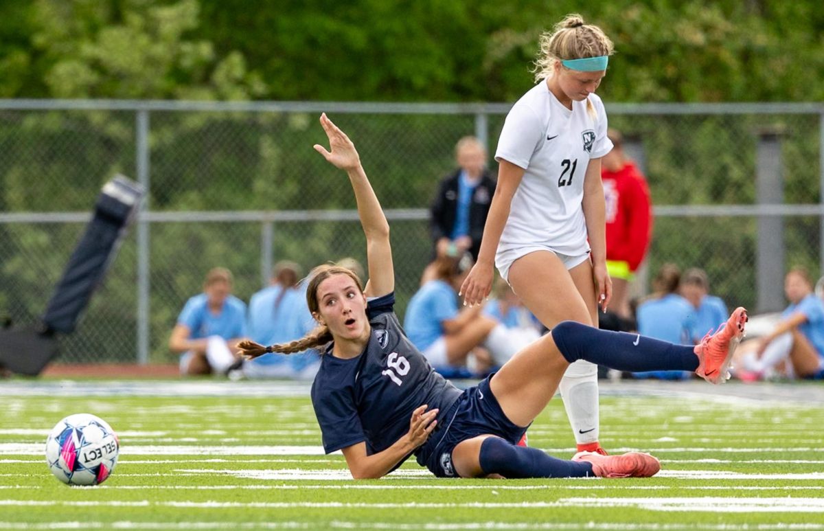 After getting tripped, junior Claire Casler holds her arm up in disbelief at the referee not calling a foul. Both referees conversed with each other and came to the consensus that the player from North committed a foul. 