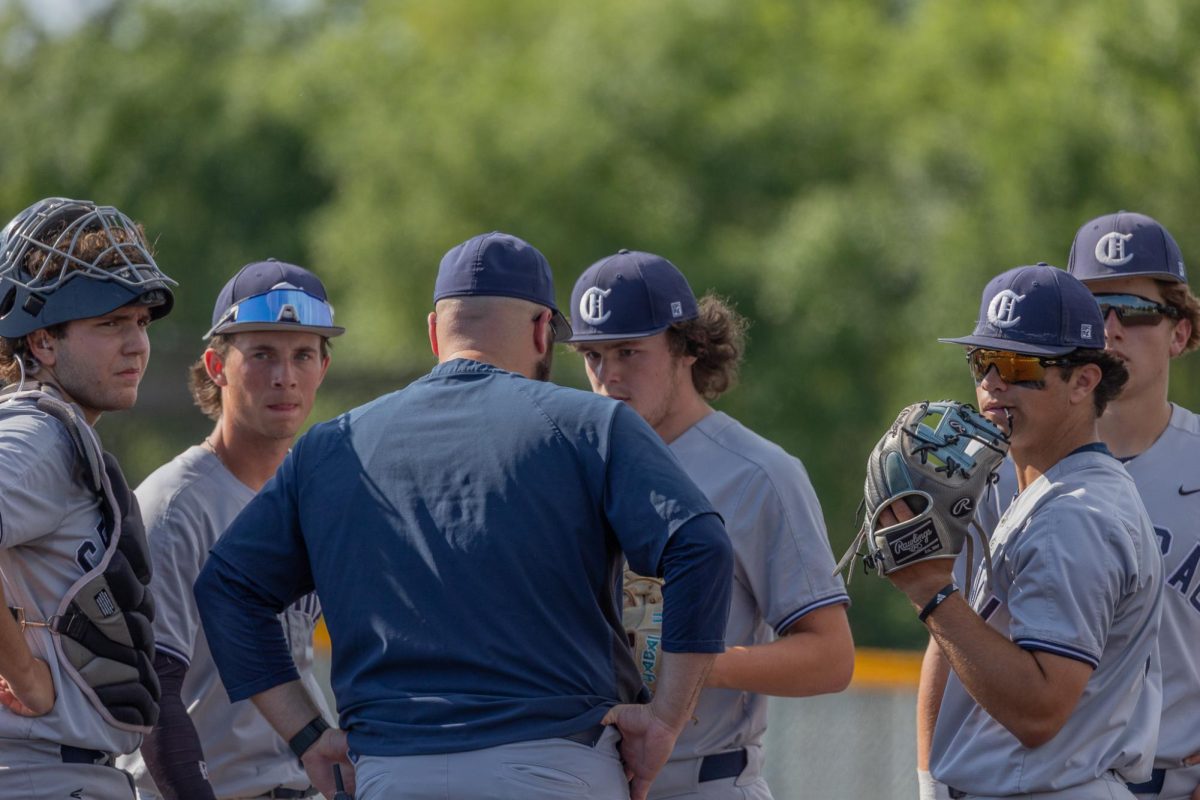 Assistant coach Jake Mulehlenbrock walks out to the mound to talk with the infield. As coach Muehlenbrock talked to senior Thomas Masterson the rest of the infield looked over to the dugout.