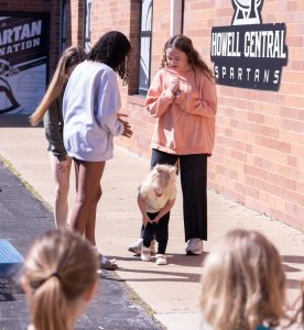 On May 6th, 2025, A student in Child Development II carefully watches one of the preschoolers the class takes care of during the class hour while she plays outside. With the permission of their parents and/or guardians, the children came in three days a week, for four hours each day.
