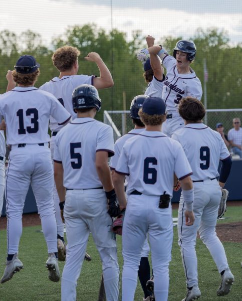 Senior Sam Mueller jogs around the bases after hitting a homerun off of Francis Howells pitcher. Mueller then jumped up along with his teammates to celebrate. 