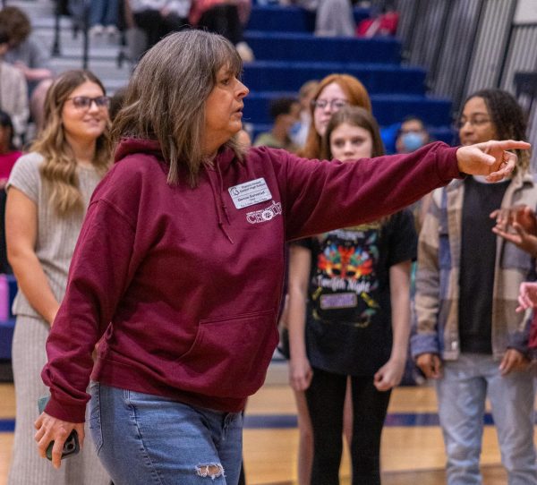 Mrs. Donna Solverud directing the choir during their performance at the Spring Pep assembly.