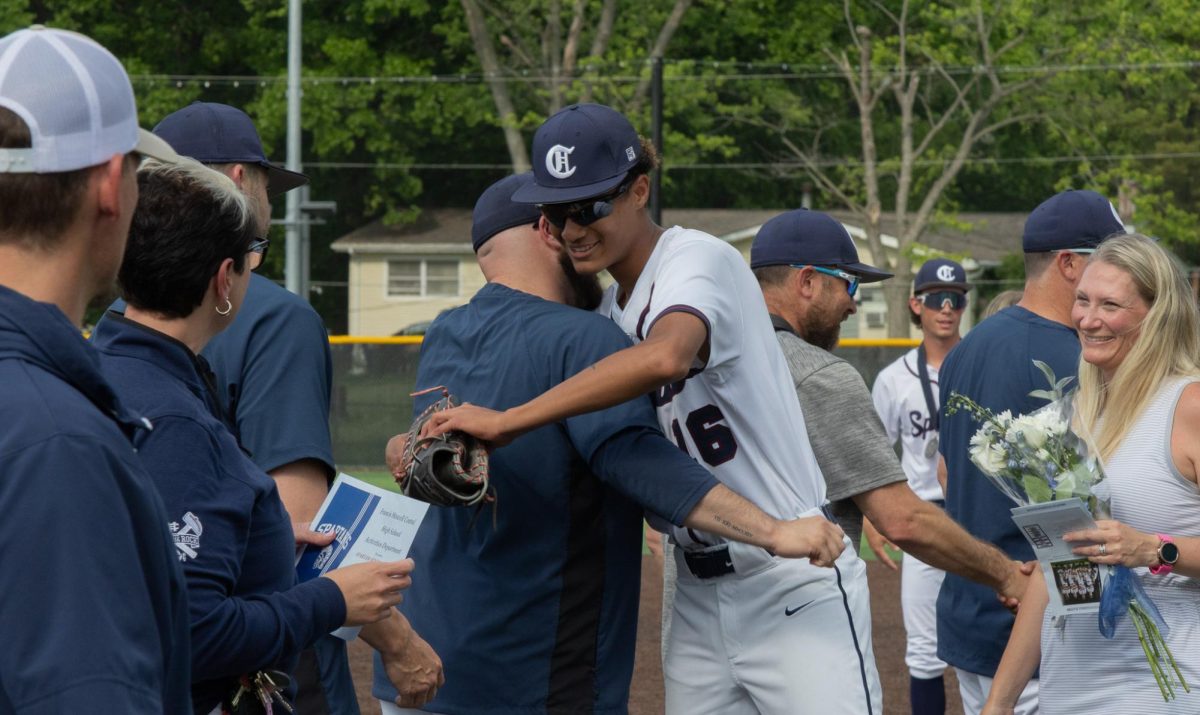 While walking down the line of coaches to shake everyone's hand, senior Ethan LeFlore hugs his coach. LeFlore then went on to shake everyone else's hand, and he then received his award for senior night. 