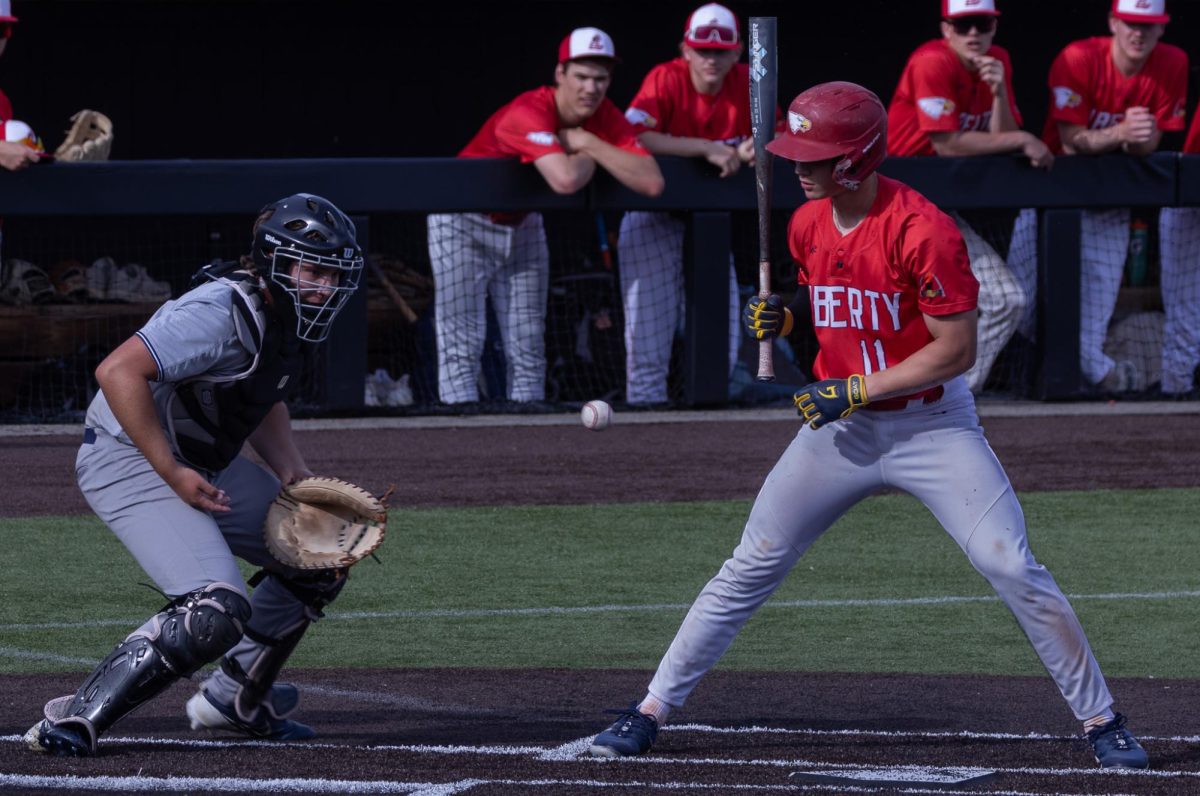 The opposing team’s batter and senior Owen Meyer watch the ball as it begins to bounce away from Meyer after it hits his chest. Meyer followed by catching up with the rogue ball and returning it to the pitcher.