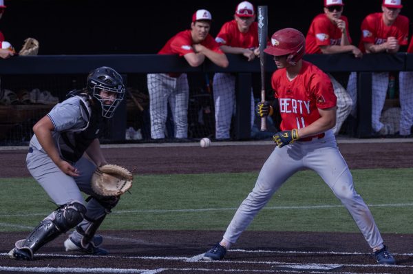 The opposing team’s batter and senior Owen Meyer watch the ball as it begins to bounce away from Meyer after it hits his chest. Meyer followed by catching up with the rogue ball and returning it to the pitcher.