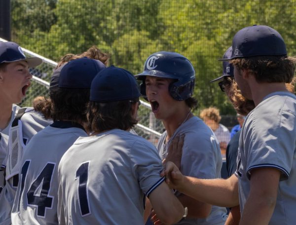 The team hollers as they surround senior Noah Gunnar after he scores a point for the team. At almost every point that was scored in the game, the players shouted and ran out onto the field to congratulate the player.