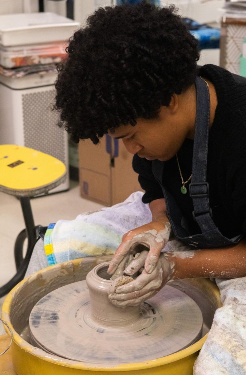 Sophomore Jacob Banks creates pottery in Michelle Ridlen's Ceramics II art class. His ability to manipulate the clay represents the nature of pottery in relation to digital alternatives: harder to control and more unpredictable. 