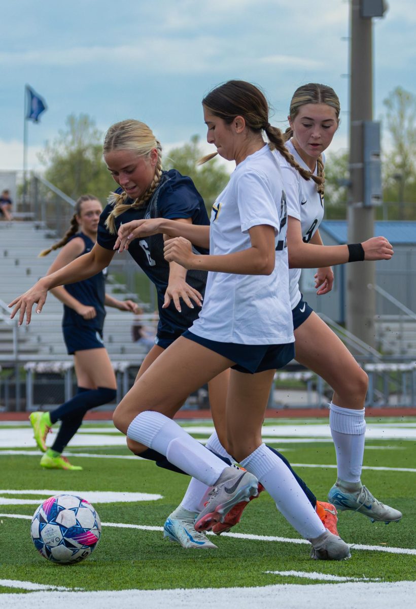 After getting the ball back in their possession, senior Julia Peters fights hard to keep it. As it was a close call, Peters was able to fight hard and keep the ball in their possession, running it closer to the goal.

