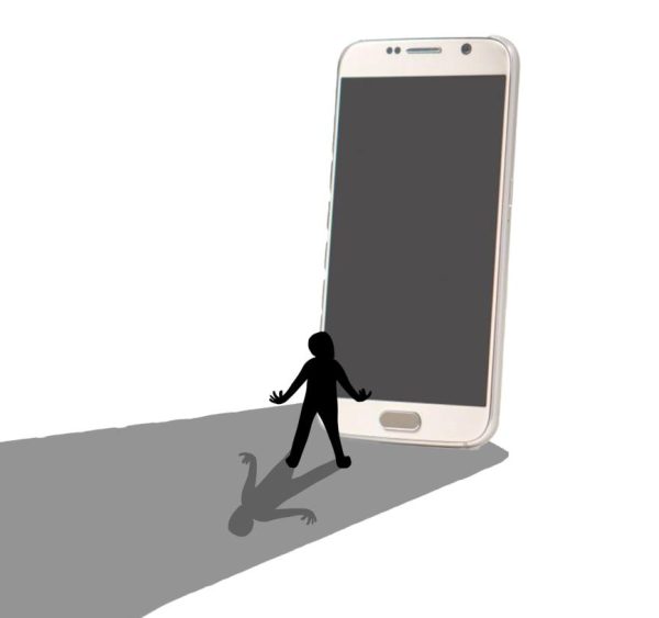 A person stands beside a large phone towering over them, overshadowing their own shadow. Technology is helpful but can sometimes become a detriment when used in excess. Photo Illustration by Birdie Brereton